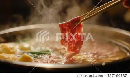 Sliced Beef Dipped in Steaming Hot Pot Broth with Chopsticks Sliced Beef Dipped in Steaming Hot Pot Broth with Chopsticks 127169187