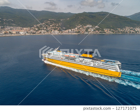 Big yellow passenger ferry goes on the Mediterranean Sea near Corsica island, France aerial view Cityscape Bastia port 127171075