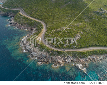Aerial view car Roadtrip Winding road along rocky coast of Cap Corse peninsula on Corsica island France Aerial view car Roadtrip Winding road along rocky coast of Cap Corse peninsula on Corsica island France 127171078