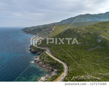 Aerial view car Roadtrip Winding road along rocky coast of Cap Corse peninsula on Corsica island France 127171080
