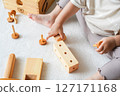 Children's hands playing with wooden toys 127171168