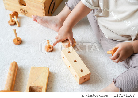 Children's hands playing with wooden toys Children's hands playing with wooden toys 127171168