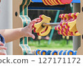 Children's hands playing on playground equipment in the park 127171172