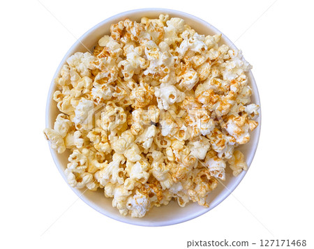 Top view of a bowl filled with delicious caramel and butter popcorn, isolated on white background. Perfect snack for movie night, party, or food advertisement. 127171468
