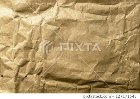 Aged crumpled brown paper texture of used parcel packaging. Abstract grunge background Aged crumpled brown paper texture of used parcel packaging. Abstract grunge background 127171545