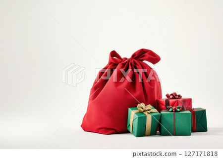 Red gift bag overflowing with colorful wrapped boxes in red and green shades. Minimalist white background, festive ribbons, perfect for Christmas, New Year, and holiday advertising design. Copy space 127171818