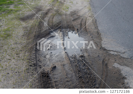 Dirty Mud Road with Water with Car Track Dirty Mud Road with Water with Car Track 127172186