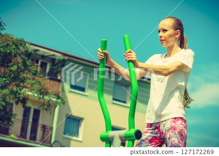 Girl exercise at outdoor gym area 127172269