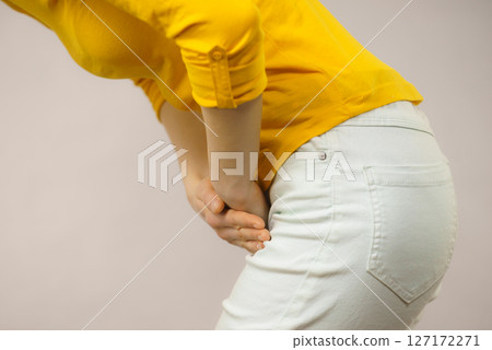 Woman with hands holding her crotch Woman with hands holding her crotch 127172271