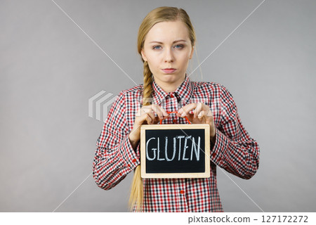 Woman holding board with gluten sign Woman holding board with gluten sign 127172272