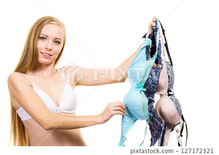 Woman holds bras, choosing 127172321