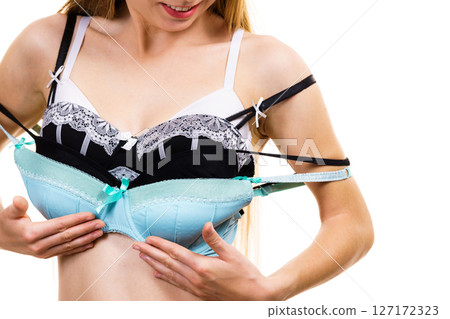 Woman holds bras, choosing 127172323