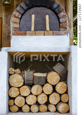 wood burning oven for outdoor cooking and prepared logs for kindling wood burning oven for outdoor cooking and prepared logs for kindling 127172687