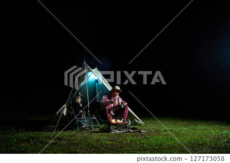 Solo camper eating ramen for midnight snack Solo camp Senior 127173058