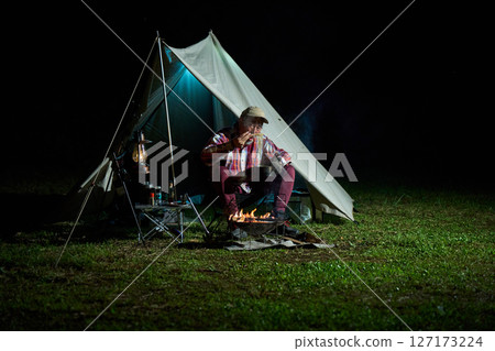 Solo camper eating ramen for midnight snack Solo camp Senior 127173224