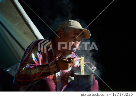 Solo camper eating ramen for midnight snack Solo camp Senior Solo camper eating ramen for midnight snack Solo camp Senior 127173230