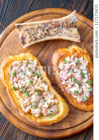 Toasted marrow sandwiches garnished with thyme served on crusty golden bread slices Toasted marrow sandwiches garnished with thyme served on crusty golden bread slices 127173433