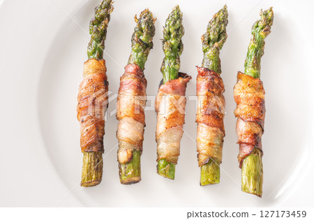 Crispy Fried Asparagus Wrapped In Bacon Served Simply On White Plate Crispy Fried Asparagus Wrapped In Bacon Served Simply On White Plate 127173459