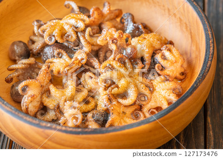 Golden Fried Garlic Octopuses Served In Rustic Wooden Bowl With Crisp Edges 127173476