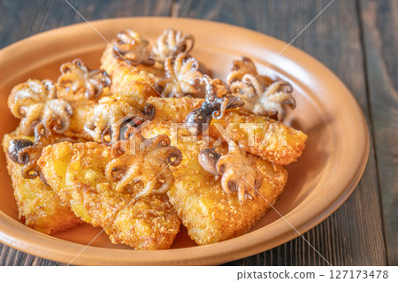 Golden Potato Rosti With Baby Octopuses Served On Rustic Wooden Table Plate 127173478