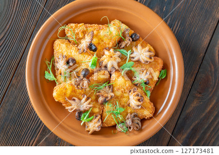 Golden Potato Rosti With Baby Octopuses And Fresh Pea Shoots Garnished Delicately 127173481