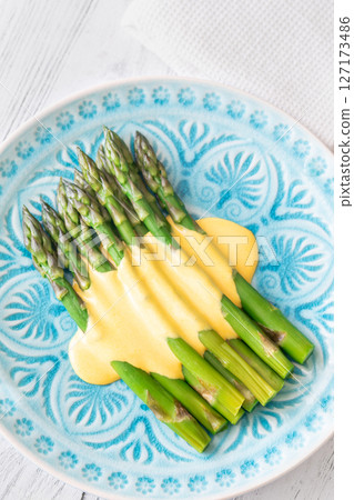 Blue Plate of Boiled Asparagus Drizzled in Silky Hollandaise Sauce 127173486