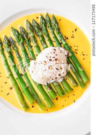 White Plate of Asparagus Nestled in Hollandaise Sauce With Poached Egg White Plate of Asparagus Nestled in Hollandaise Sauce With Poached Egg 127173488