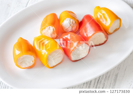 Colorful Baby Bell Peppers Stuffed With Cream Cheese on White Plate 127173830
