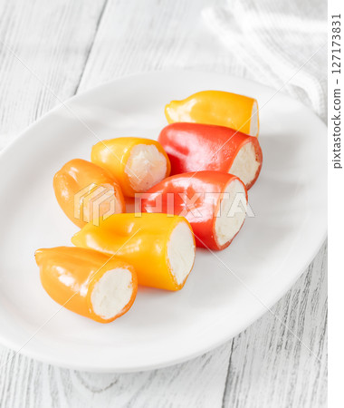 Colorful Baby Bell Peppers Stuffed With Cream Cheese on White Plate 127173831