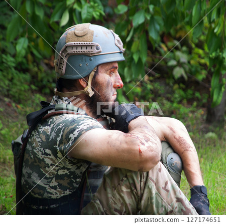 Lone sad soldier sitting in the forest 127174651