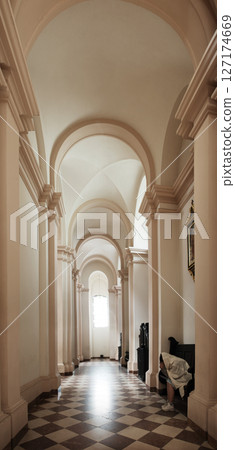 Girl sit on the bench in the church 127174669