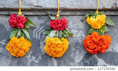 Vibrant Red Orange Yellow Marigold Flower Bouquets Hanging Stone Wall life vivid image photo still 127176588