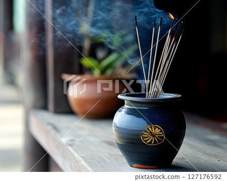 Burning Incense Sticks in Elegant Blue Ceramic Holder Peaceful Meditation Spiritual Atmosphere 127176592