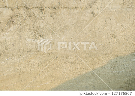 Background texture of a concrete wall with a thin layer of sand all over it 127176867