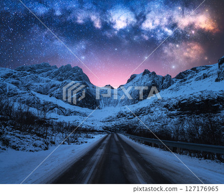 Milky Way over road, snowy mountains at winter starry night 127176965