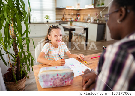 Joyful moments of creativity between a child and a mentor 127177002