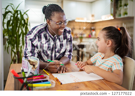 Creative bonding moments in a cozy kitchen setting 127177022