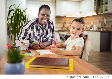 Creative moments between a joyful mentor and a young artist 127177023