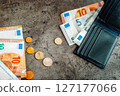 Finance. Money banknotes, coins and black wallet. Euros on dark background 127177066