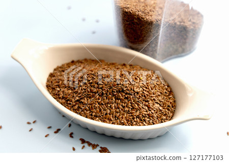 Healthy uncooked raw flax seeds in a bowl Healthy uncooked raw flax seeds in a bowl 127177103