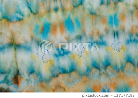abstract pattern on silk fabric texture in blue, yellow, green colors abstract pattern on silk fabric texture in blue, yellow, green colors 127177192