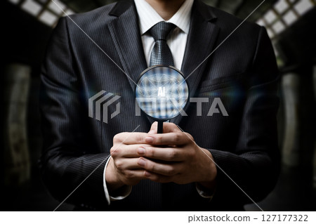 Pro in suit examines AI symbol with magnifier. Pro in suit examines AI symbol with magnifier. 127177322