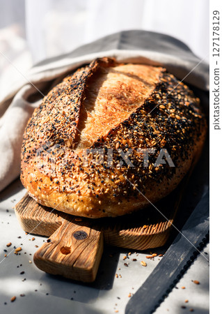 Crispy sourdough bread with cracked crust and rugged texture Crispy sourdough bread with cracked crust and rugged texture 127178129