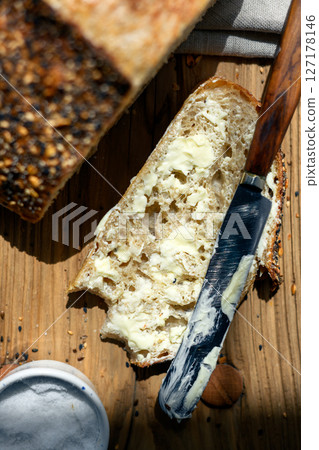 Top view of sliced white sourdough bread with butter and knife Top view of sliced white sourdough bread with butter and knife 127178146