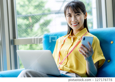 A woman using a laptop computer at a cafe A woman using a laptop computer at a cafe 127178778