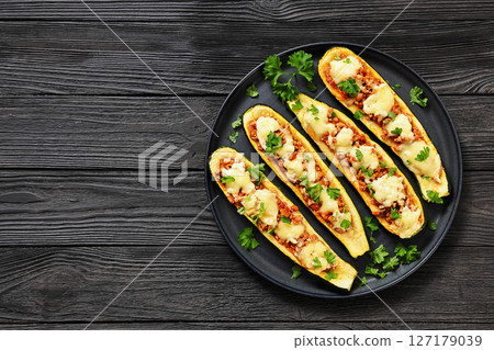 stuffed zucchini boats filled with bolognese sauce 127179039