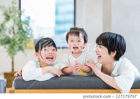 A family relaxing in the living room. A family relaxing in the living room. 127179797