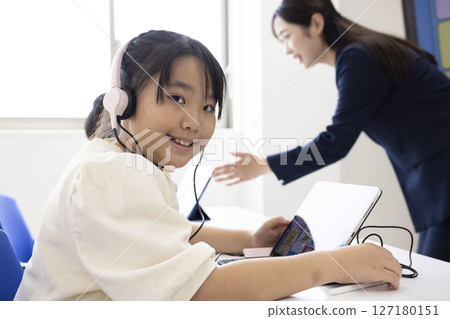 Female child using a tablet 127180151