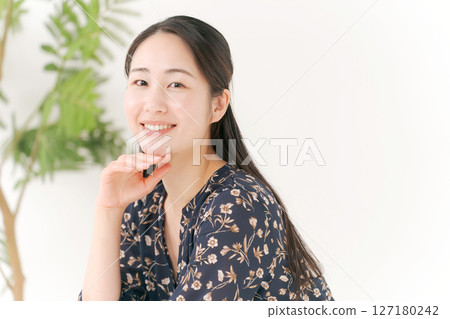 一個年輕的女人帶著微笑 一個年輕的女人帶著微笑 127180242