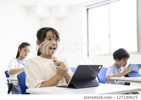 Children taking classes using tablets Children taking classes using tablets 127180625